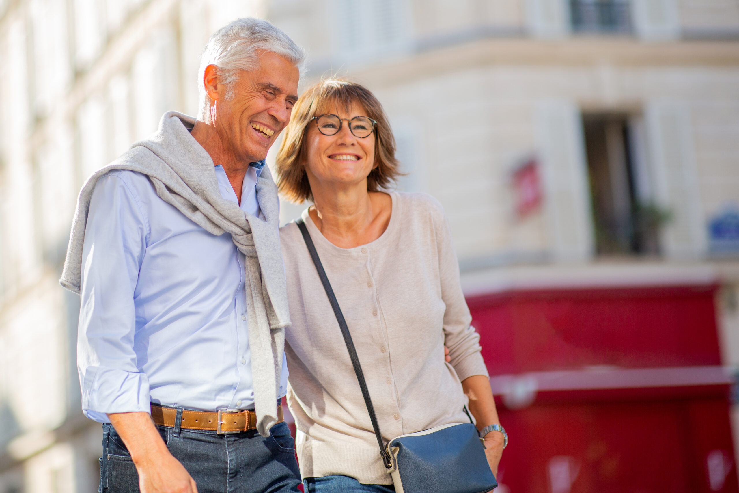 Portrait happy mature couple walking outside in city