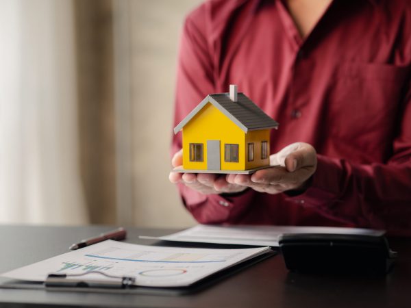 House sales representatives, sales representatives recommend housing details in the project to customers who are interested in viewing the houses in the project. Real estate trading concept.