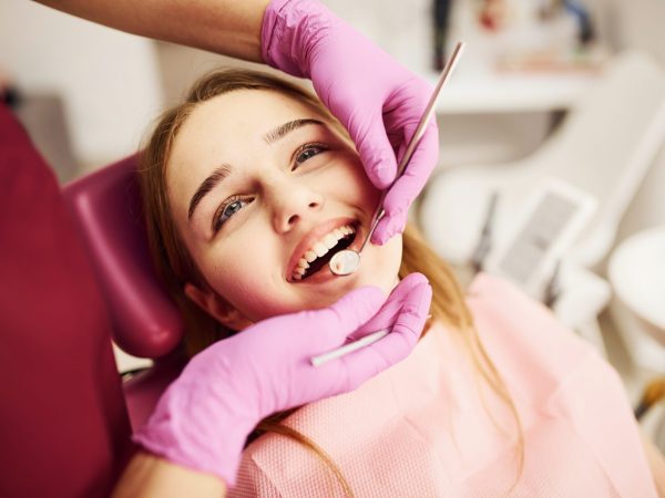 Little girl visiting dentist in clinic. Conception of stomatology.